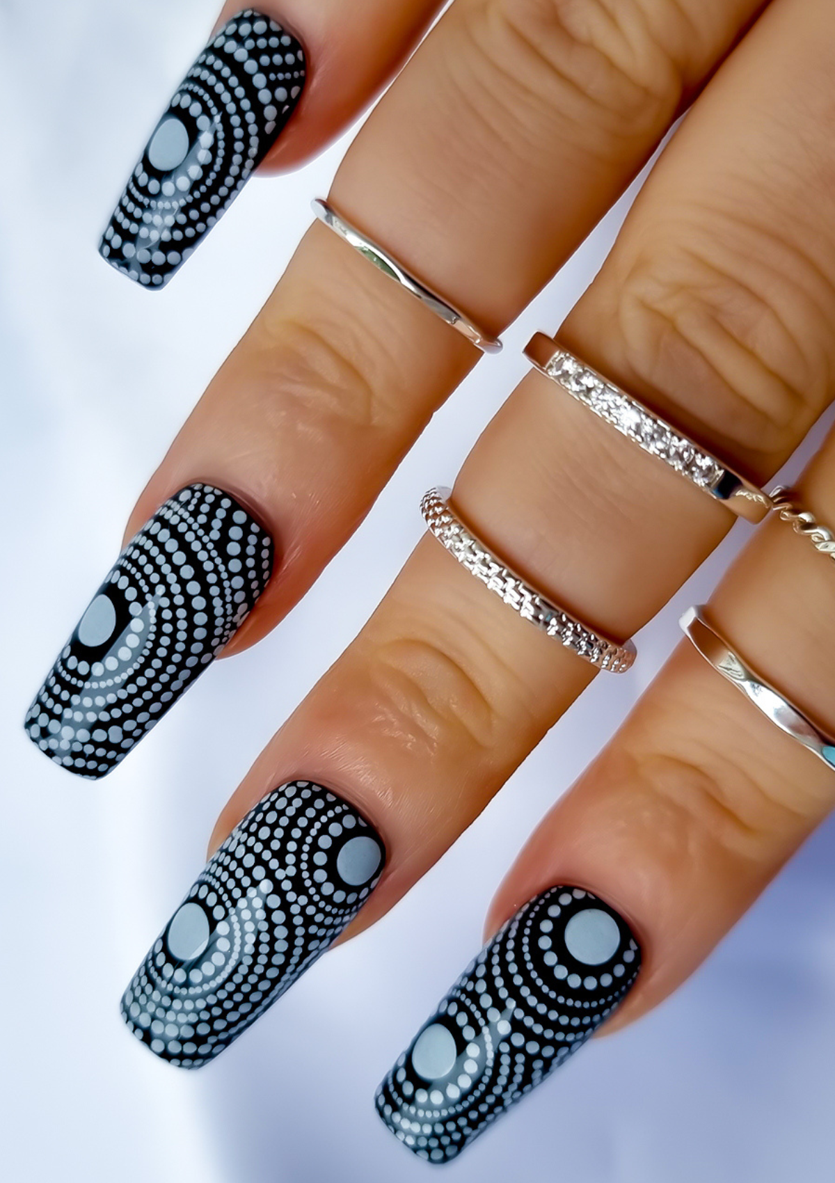 Black nails with white Aboriginal Australian nail art designs