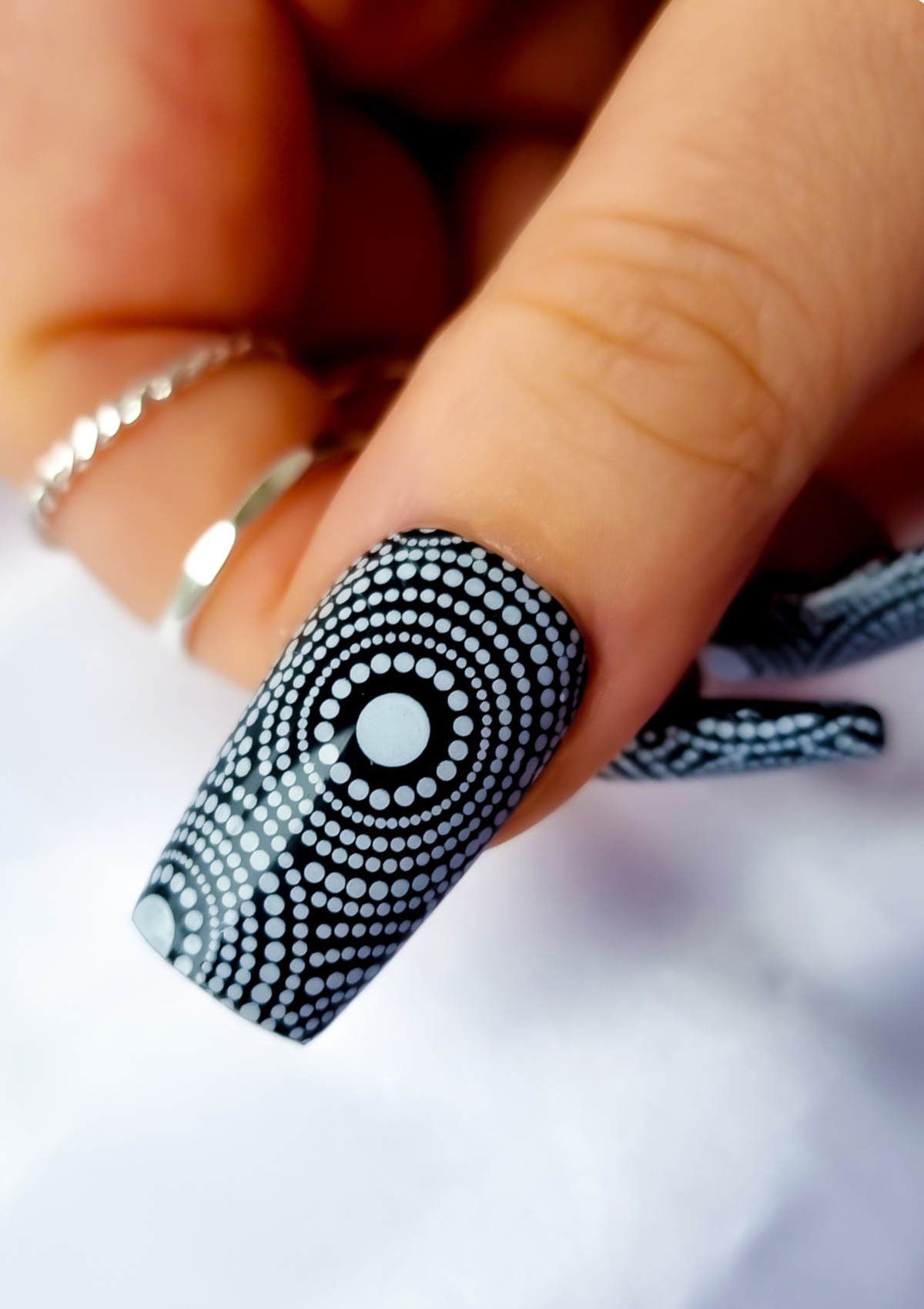 Black nails with white Aboriginal Australian nail art designs