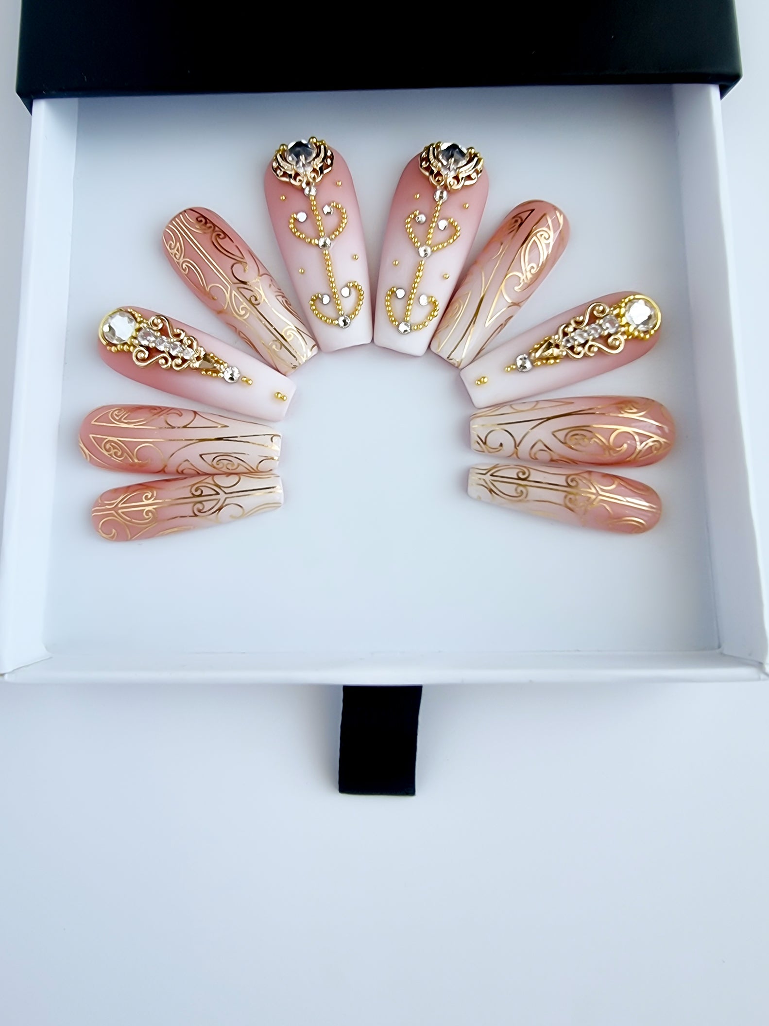 Baby boomer press-on nails with Gold Maori Nail Foils and gold koru charms