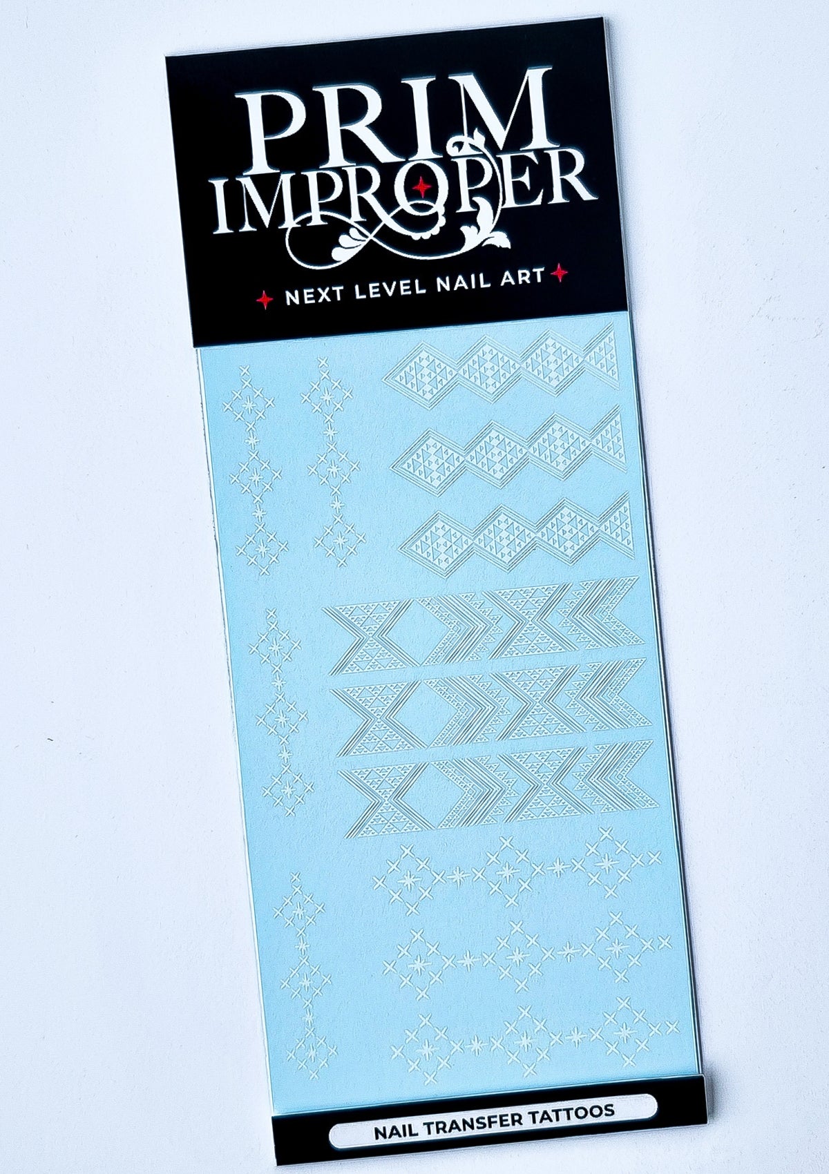 Sheet of White Nail Transfer Tattoos designed by Adrienne Whitewood featuring Aonui, Taniko Hou and Ngā Whetu patterns.
