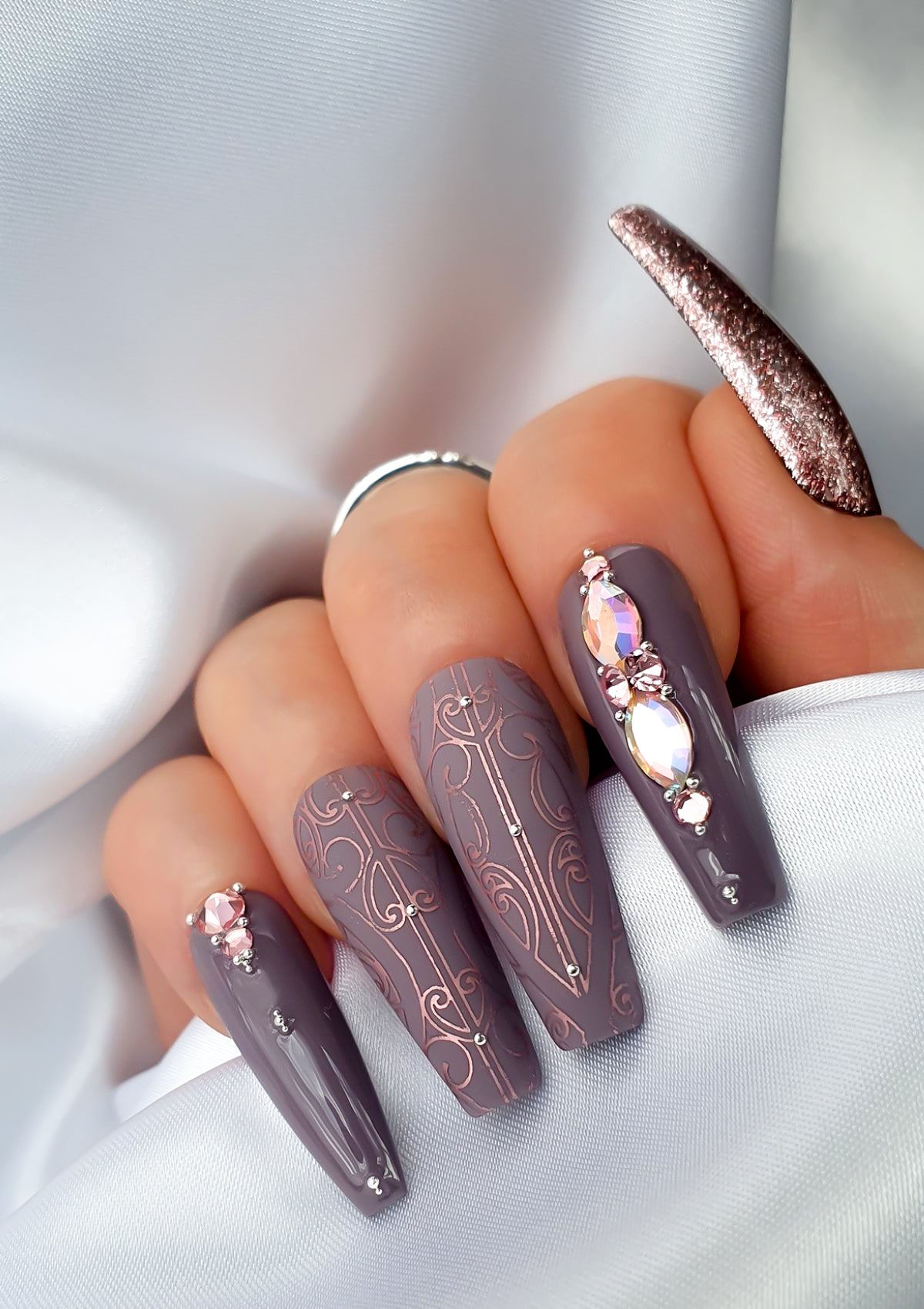 Mauve nails with rose pink Maori Nail Foils  and crystals 