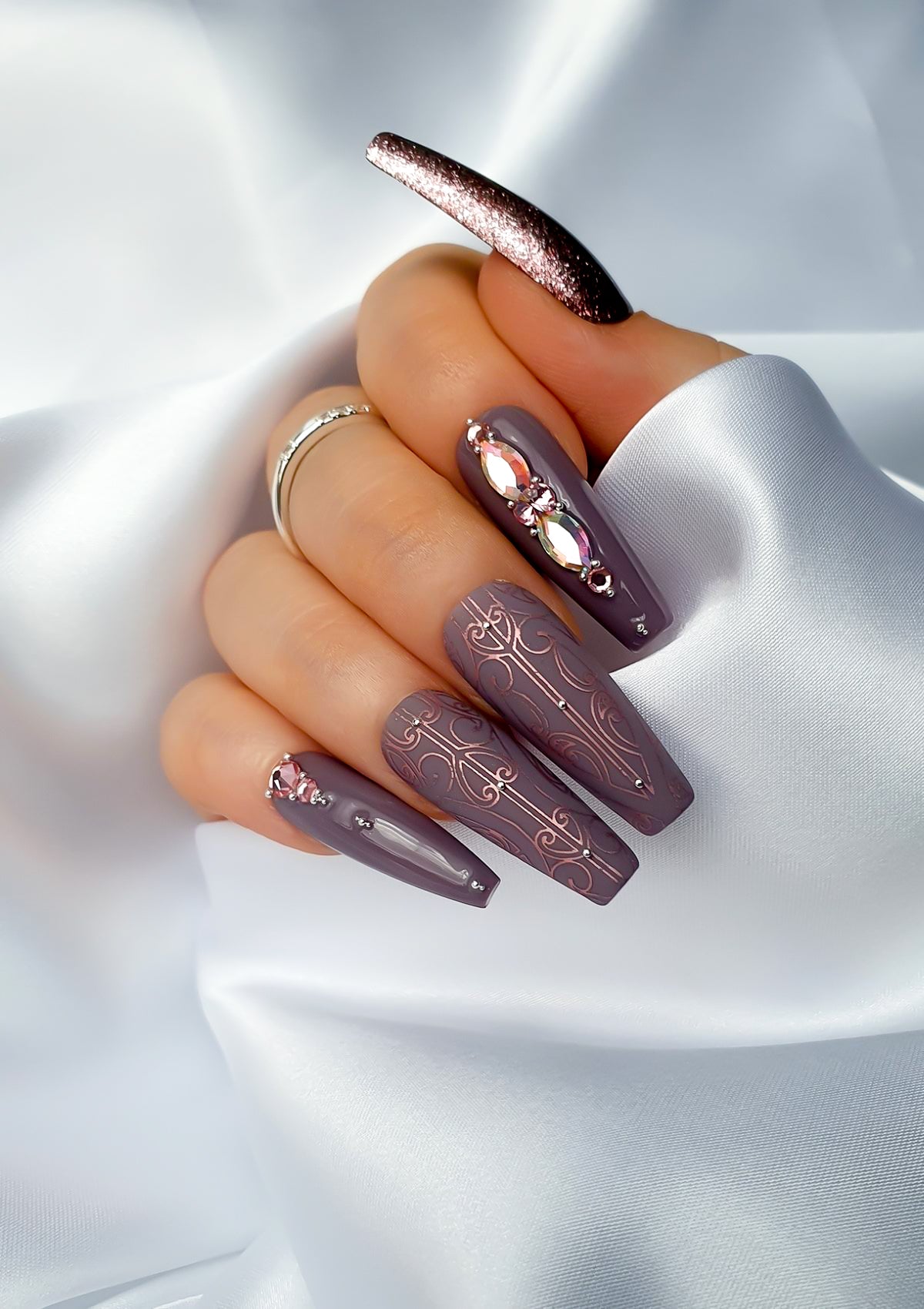 Mauve nails with rose pink Maori Nail Foils  and crystals 