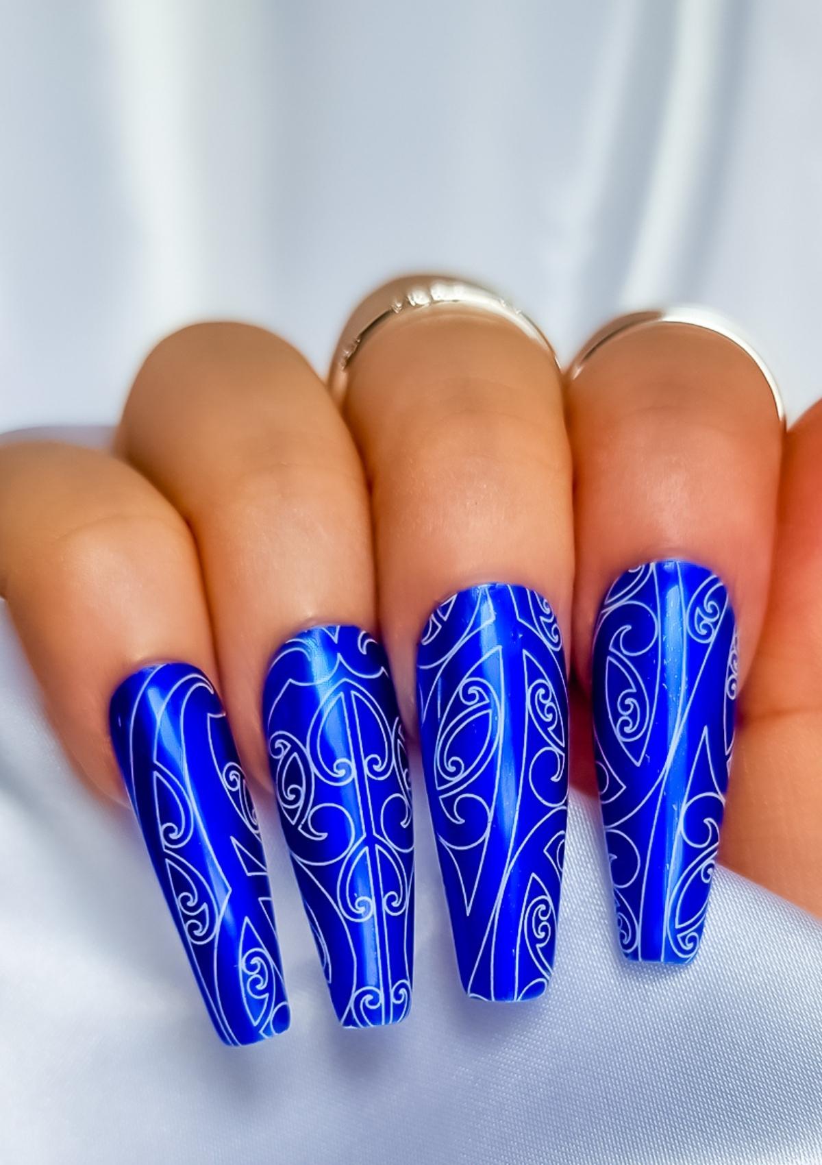 Dark blue nails with white Maori designs 